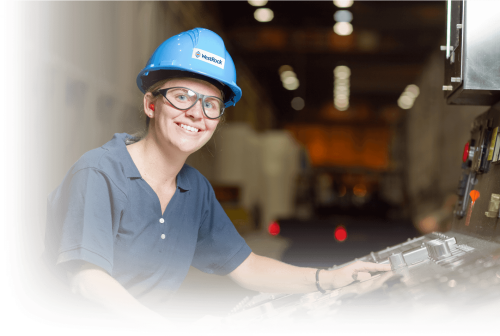 A Woman In A Blue Shirt And Blue Hard Had Working On Hard Hat